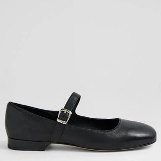 Black leather flat shoe with a buckle on a light gray background