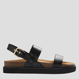 A pair of black leather HUNTER sandals with adjustable strap and gold buckle, on a cork-like sole.