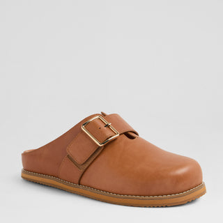 Brown leather clog with a gold buckle on a light gray background