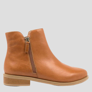 A tan ankle boot with a twin zip design on the side, a low heel, and a flat sole.